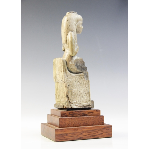 150 - An Egyptian style fragmentary steatite statue of Isis seated on her throne, the figure of the child ... 