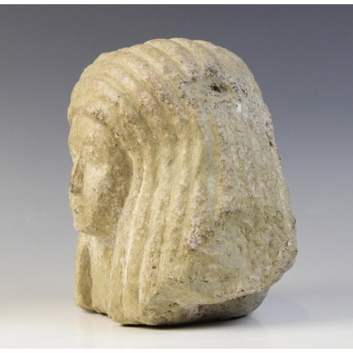 153 - An Egyptian style limestone bust of a woman, 16.5cm high and an Egyptian style stone head of a baboo... 