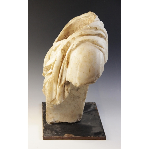 155 - A Roman marble bust with the folds of the tunic deeply carved, set on an integral  tapered socle, ci... 