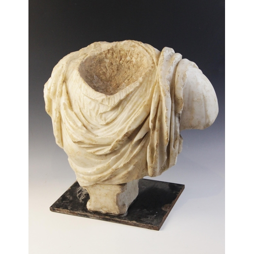 155 - A Roman marble bust with the folds of the tunic deeply carved, set on an integral  tapered socle, ci... 