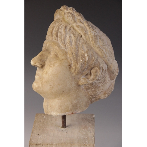 156 - A marble head of an emperor, probably Nero, wearing a wreath, After the Antique, 23.5cm high (at fau... 