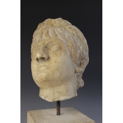 156 - A marble head of an emperor, probably Nero, wearing a wreath, After the Antique, 23.5cm high (at fau... 