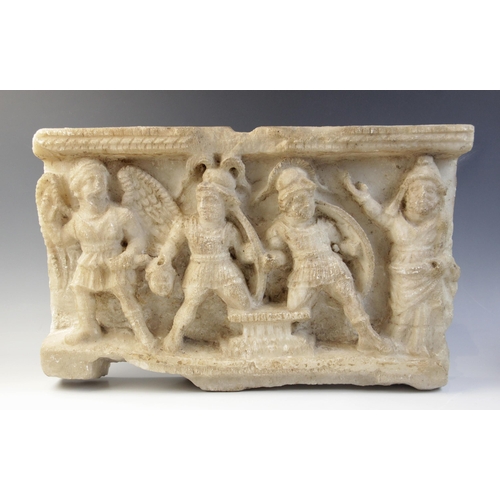 161 - A marble rectangular relief deeply carved with four figures, two shield-bearing soldiers, one carryi... 