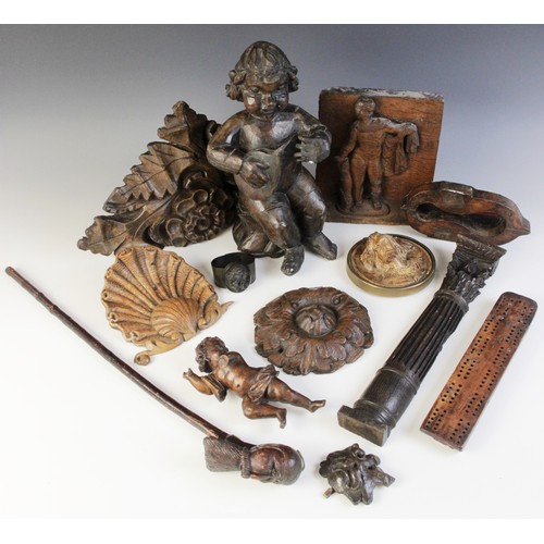 483 - A selection of carved wood items, to include a carved oak panel, carved with a figure, 21cm high, a ... 