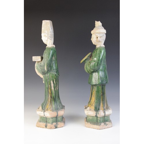 344 - A pair of large Chinese Sancai glazed attendants, possibly Ming dynasty, male and female, one modell... 