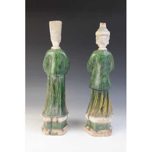 344 - A pair of large Chinese Sancai glazed attendants, possibly Ming dynasty, male and female, one modell... 