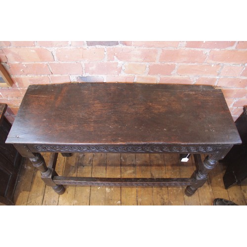 543 - A 16th/17th century and later constructed oak side table, the board top above a frieze carved with a... 