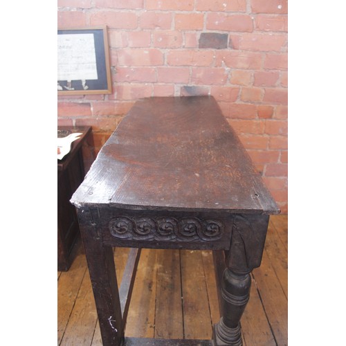 543 - A 16th/17th century and later constructed oak side table, the board top above a frieze carved with a... 