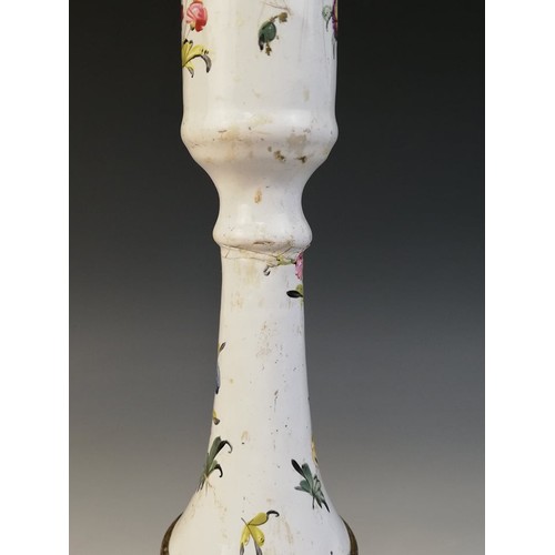24A - An 18th century Bilston enamel candlestick, of knopped form on shaped base, decorated with floral sp... 
