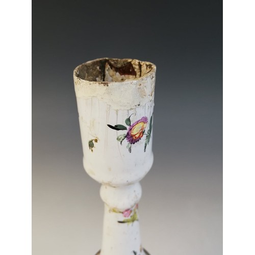 24A - An 18th century Bilston enamel candlestick, of knopped form on shaped base, decorated with floral sp... 
