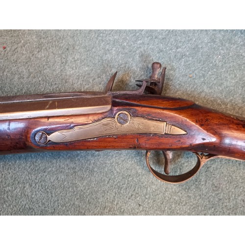 66 - A replica Flintlock Blunderbuss, the round bronze barrel stamped ‘A093’, half-stocked in walnut and ... 