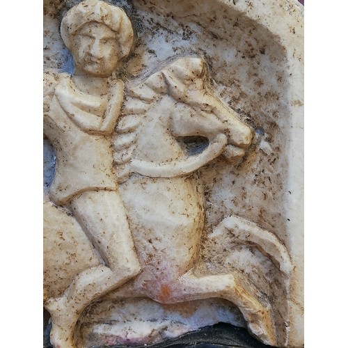 117 - A Roman marble stele carved in high relief with the 'Thracian horseman', the remains of what is like... 