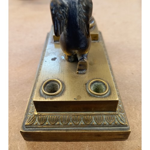 48 - A brass desk inkwell, 19th century, designed as a cherub kneeling before a memorial plinth, surmount... 