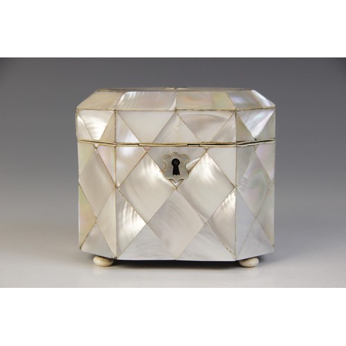 48A - A 19th century mother of pearl and ivory tea caddy, the rectangular caddy with canted corners raised... 