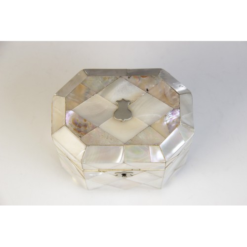 48A - A 19th century mother of pearl and ivory tea caddy, the rectangular caddy with canted corners raised... 