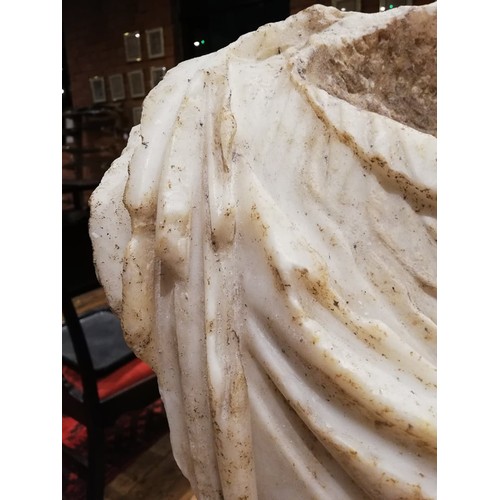 155 - A Roman marble bust with the folds of the tunic deeply carved, set on an integral  tapered socle, ci... 