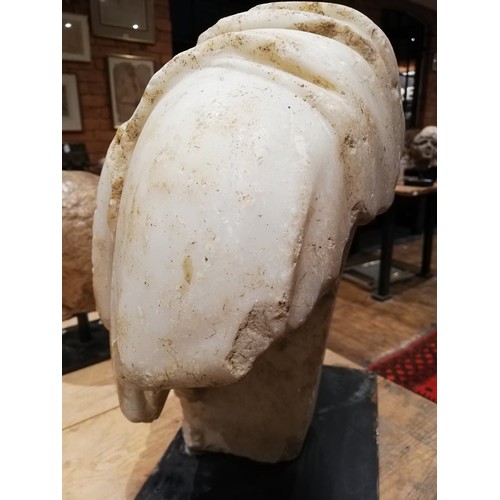 155 - A Roman marble bust with the folds of the tunic deeply carved, set on an integral  tapered socle, ci... 