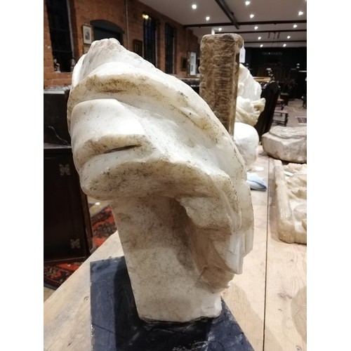 155 - A Roman marble bust with the folds of the tunic deeply carved, set on an integral  tapered socle, ci... 