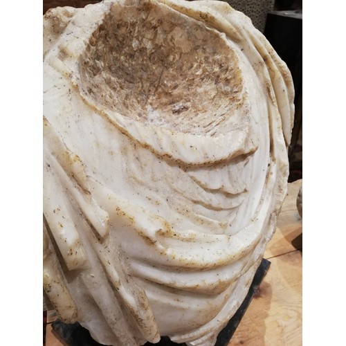 155 - A Roman marble bust with the folds of the tunic deeply carved, set on an integral  tapered socle, ci... 