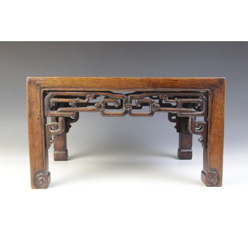 304 - A Chinese hardwood and rouge marble urn stand, of rectangular form with interlinked openwork frieze,... 