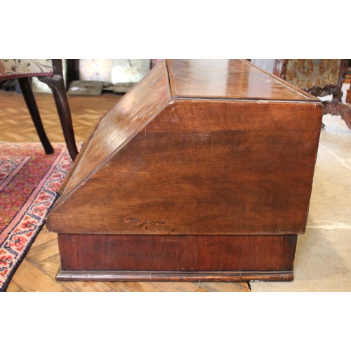 560 - A William and Mary and later figured walnut bureau, in two sections, the feather banded fall front o... 