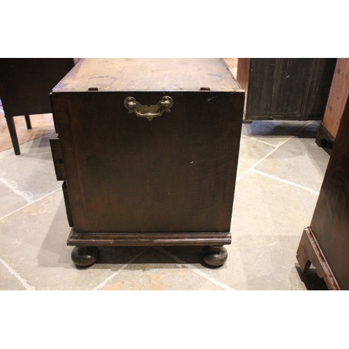 560 - A William and Mary and later figured walnut bureau, in two sections, the feather banded fall front o... 