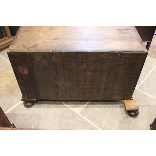 560 - A William and Mary and later figured walnut bureau, in two sections, the feather banded fall front o... 