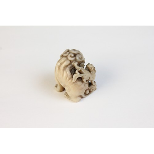 300 - * A Chinese carved stone model of a Dog of Fo, designed with two playful cubs, 3.5cm high, with a ca... 