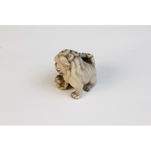 300 - * A Chinese carved stone model of a Dog of Fo, designed with two playful cubs, 3.5cm high, with a ca... 