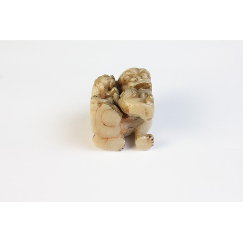 300 - * A Chinese carved stone model of a Dog of Fo, designed with two playful cubs, 3.5cm high, with a ca... 