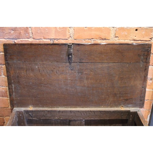 571 - An 18th century oak coffer of cottage proportions, the rectangular moulded top above twin panels eac... 