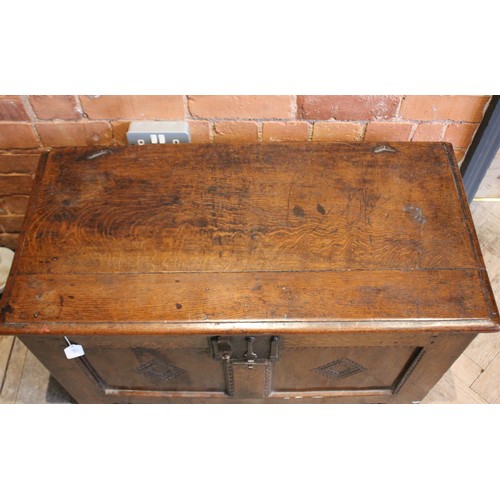 571 - An 18th century oak coffer of cottage proportions, the rectangular moulded top above twin panels eac... 