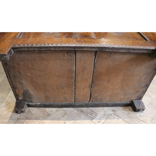 571 - An 18th century oak coffer of cottage proportions, the rectangular moulded top above twin panels eac... 