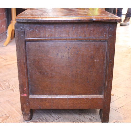 571 - An 18th century oak coffer of cottage proportions, the rectangular moulded top above twin panels eac... 