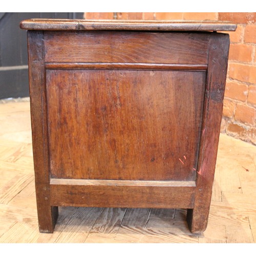 571 - An 18th century oak coffer of cottage proportions, the rectangular moulded top above twin panels eac... 