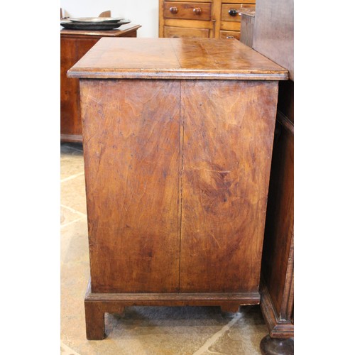 574 - A George II figured walnut kneehole desk, the quarter veneered and crossbanded top with a moulded ri... 