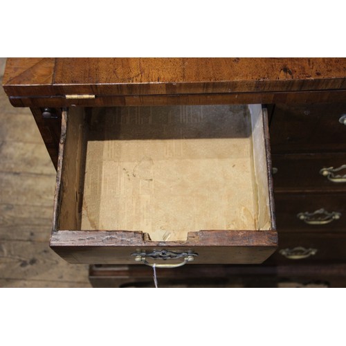 527 - A George II style walnut fold over bachelors chest, the crossbanded folding top above two short and ... 