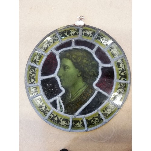 375 - An oval stained and painted glass portrait panel, 19th century, depicting a young gentleman in ornat... 