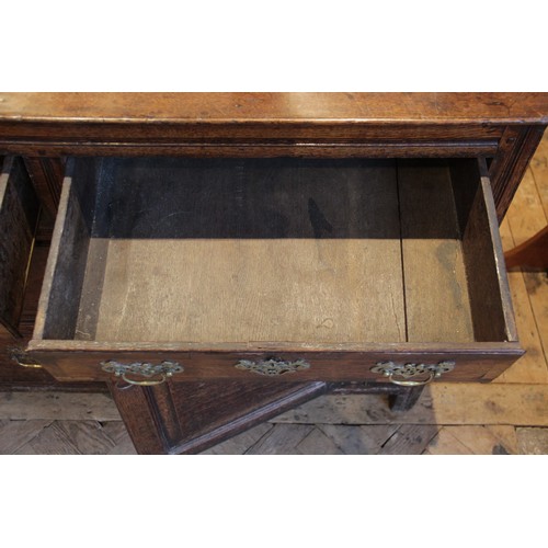 530 - A George II oak dresser base, the rectangular top with inverted front corners over three mahogany cr... 