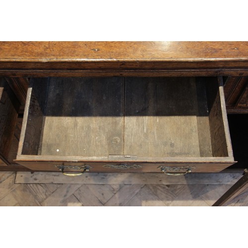 530 - A George II oak dresser base, the rectangular top with inverted front corners over three mahogany cr... 