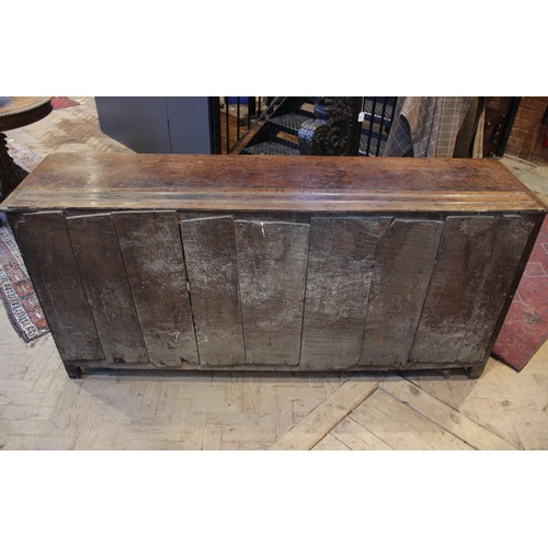 530 - A George II oak dresser base, the rectangular top with inverted front corners over three mahogany cr... 