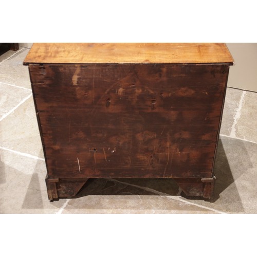 545 - An early 18th century figured walnut bachelors chest of drawers, the rectangular top with a moulded ... 