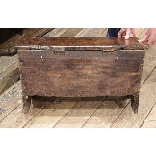 561 - A mid 17th century and later Welsh oak six plank coffer bach, the hinged top with a serrated edge an... 