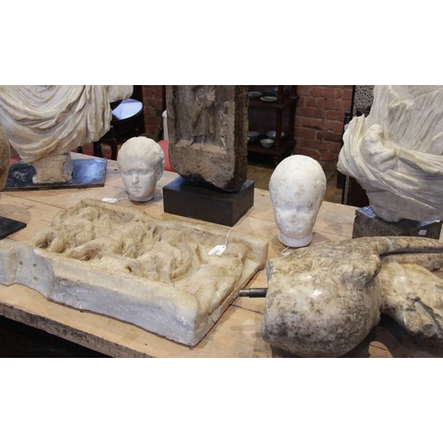 140 - A Roman style head of a young woman, with worn features, her hair drawn back into a tight plaited bu... 