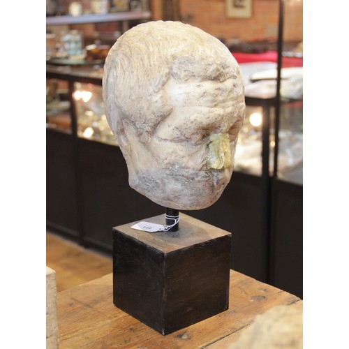 146 - A worn marble male head carved with furrowed brow, with restorations, height excluding base approxim... 