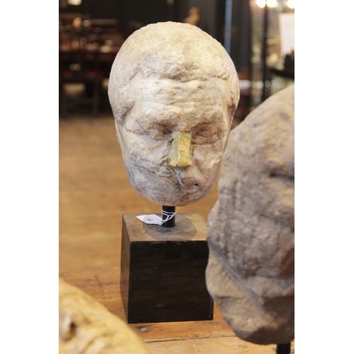 146 - A worn marble male head carved with furrowed brow, with restorations, height excluding base approxim... 