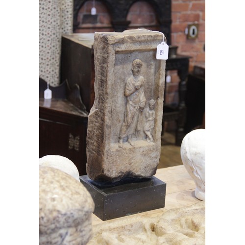 163 - A marble grave stele of rectangular form, the recessed area carved in relief with a standing male fi... 