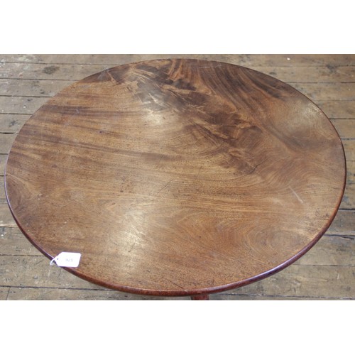 576 - A George III mahogany tilt top tripod table, the circular top raised upon a reduced baluster and rin... 