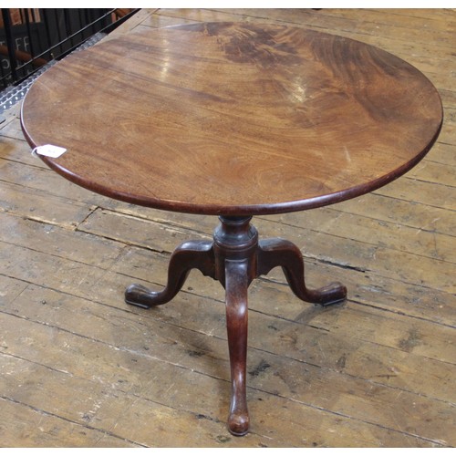 576 - A George III mahogany tilt top tripod table, the circular top raised upon a reduced baluster and rin... 