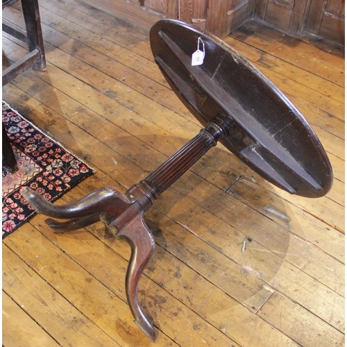 582 - A George III tripod table, the circular oak three plank top, raised upon an associated fluted column... 